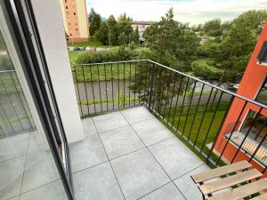 a balcony with a view of a park at Apartmán Gréner in Svit