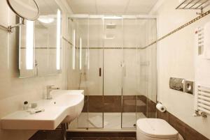 a bathroom with a shower and a sink and a toilet at Hotel Iris in Genoa