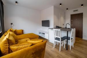 a living room with a couch and a table at Apartament Alpaka 2 in Lidzbark Warmiński