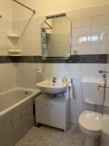 a bathroom with a sink and a toilet and a mirror at Longa Rooms in Šibenik