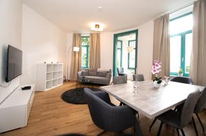 a living room with a dining room table with chairs at Room&Go: Zentral - Terrasse - Weber Grill in Halle an der Saale