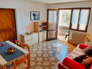 a living room with a couch and a table at Casa Maria in Ledro