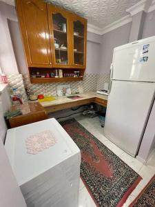a kitchen with a white refrigerator and a counter at Kumburgaz Sahilde, Sitede, Konforlu, Manzaralı Klimalı Daire in Buyukcekmece