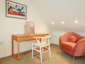 a room with a desk and a chair and a mirror at Lemon Tree in Falmouth