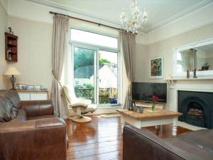 a living room with a couch and a fireplace at Detached period house in sought after location in Torquay