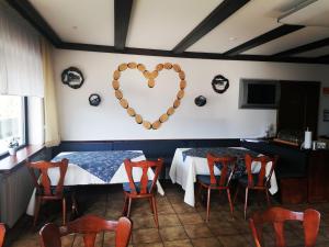 a room with a table with a heart on the wall at Haus Schwarzwaldblick in Hornberg
