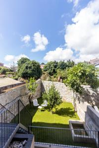 a view of a garden from the balcony of a building at Guest H4U - Porto Bonfim Heroismo in Porto
