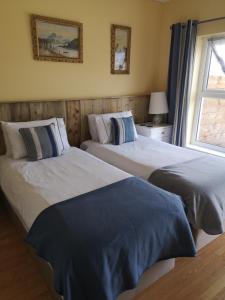 two beds sitting next to each other in a bedroom at Beautiful one bed apartment with stunning sea view in Waterford