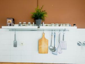 a kitchen with utensils hanging on a wall at Old Town- 4 Pers, Vieux Nice, AC, wifi in Nice