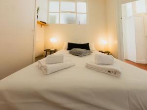 a large white bed with white towels on it at Old Town- 4 Pers, Vieux Nice, AC, wifi in Nice