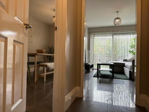 a hallway with a living room with a bed and a table at New Stylish House - Sleeps 7 - Free Parking - Contractors Welcome - Wifi in Birmingham