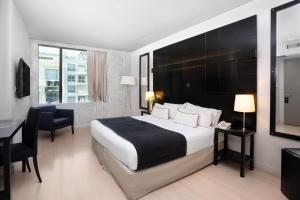 a hotel room with a large bed and a desk at Urbanica The Libertador Hotel in Buenos Aires