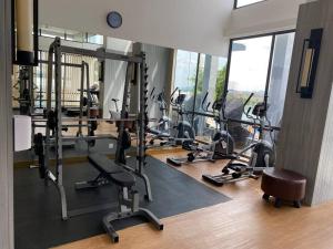 a gym with several rows of exercise bikes and a clock at Peaceful Sea view Cozy APT at Batam Center - By MESA in Batam Center