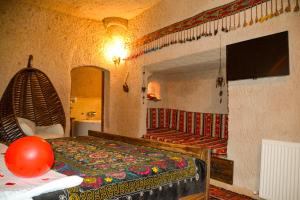 a bedroom with a bed and a staircase in a room at My Story Cave Hotel in Uçhisar