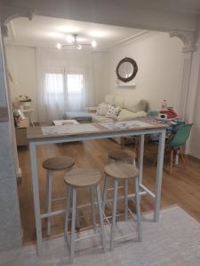 a kitchen with a table and stools in a room at Apartamento Brisa de Santander in Santander