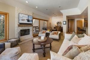 a living room with a couch and a fireplace at Village Center 611 in Durango Mountain Resort