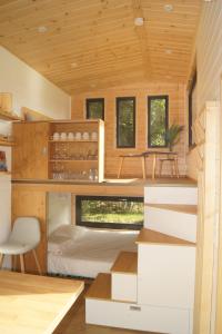 a room with a bunk bed in a house at Tiny Gaumaise - Tiny house à Saint-leger in Saint-Léger