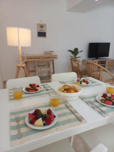 a table with plates of food on top of it at Helena's House in Nazaré +17 photos