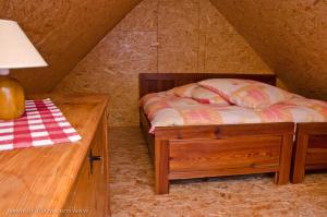 A bed or beds in a room at Drevenica JURsport Dúbrava