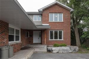a red brick house with a white door at Comfy Rooms Stay - Unit 1 in Kingston