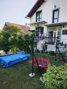 a yard with a playground and a house at Snezana home in Vranje