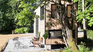 a building with chairs and a table and chairs at Tiny Gaumaise - Tiny house à Saint-leger in Saint-Léger