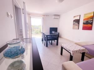 a living room with a table and a vase at Apartments Villa Marijeta with Free Parking in Zaton