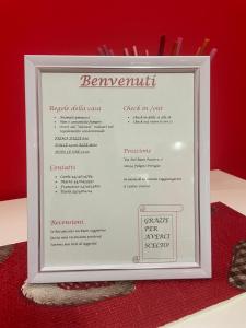 a framed menu for a restaurant on a red table at Il Nido Rosso in Foligno