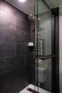 a bathroom with a glass shower with a toilet at Renaissance Chicago North Shore Hotel in Northbrook