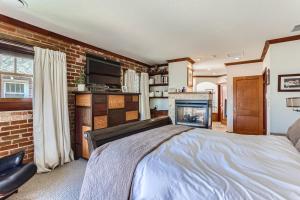 a bedroom with a bed and a fireplace at 343 S Gilpin St in Denver