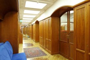a hallway with wood paneling and a row of lockers at Hotel Iris in Genoa