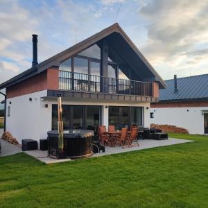 a house with a fire pit in the yard at Chata Balance in Liptovská Sielnica