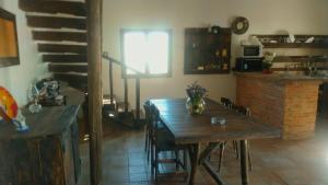 a kitchen with a wooden table and a kitchen with a counter at Casa de campo Espinosa in La Garnatilla