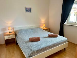 a bedroom with a bed with two towels on it at Apartments Vojvoda in Poreč