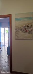 a painting of a beach with a bike on a wall at Il Tulipano in Sorrento