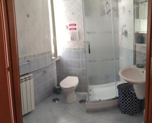 a bathroom with a shower and a toilet and a sink at Il Tulipano in Sorrento
