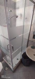 a shower with a glass door next to a sink at Il Tulipano in Sorrento