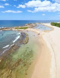 an aerial view of a beach with rocks and water at Villa Del Carmen Family Vacation Home in Isabela