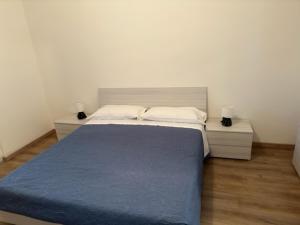 a bedroom with a large bed with two night stands at Appartamenti Monti Como Lake in Brunate