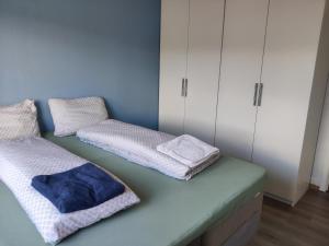 a room with two beds with towels on them at FeelHome 3 bedroom Near University in Tromsø