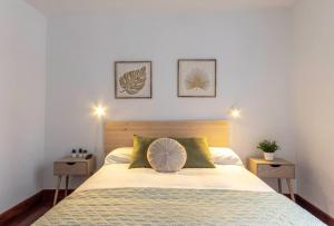 a bedroom with a large bed with two night stands at Plaza Unamuno - Casco Viejo - PARKING opcional in Bilbao
