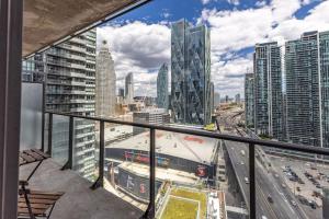a balcony with a view of a city at Cozy Downtown 2BR Suite near CN Tower with Balcony in Toronto