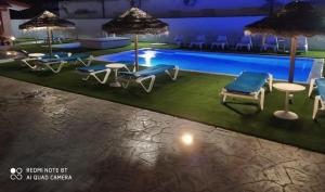 a rendering of a pool with chairs and umbrellas at La pinza bl am in El Palmar