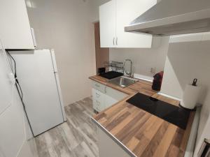 a kitchen with a white refrigerator and a sink at Centre Sweet Home in Málaga