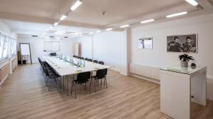 a large conference room with a long table and chairs at Hotel Amerika in Bad Schussenried