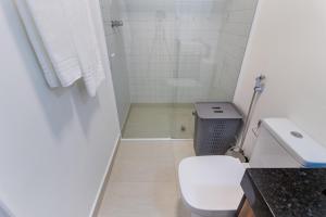 a white bathroom with a toilet and a shower at Tabas - Victoria Place - Itaim Bibi in Sao Paulo