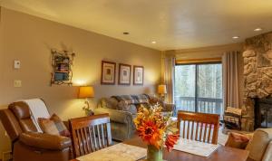 a living room with a table and a couch at Cascade Village 301 in Durango Mountain Resort