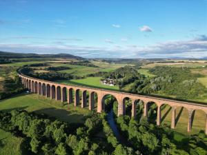 an aerial view of a viaduct in the countryside at Doura Lodge in Inverness