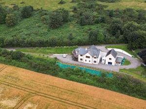 an aerial view of a large house on a hill at Doura Lodge in Inverness