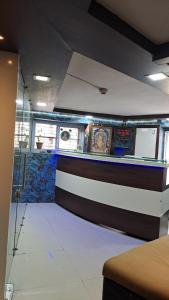 a bar in a room with a wall with stained glass at Hotel Gitanjali in Ahmedabad